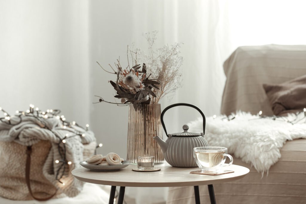 Home composition with tea and cookies in a cozy Scandinavian-inspired room interior.
