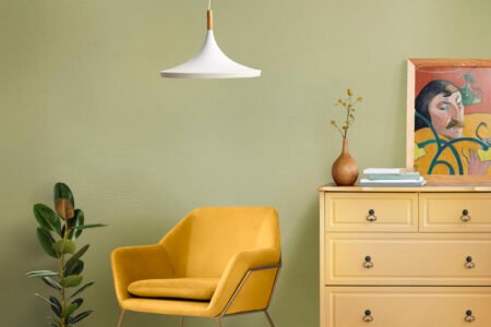 Minimalist bedroom with white bedding, wooden furniture, and open space